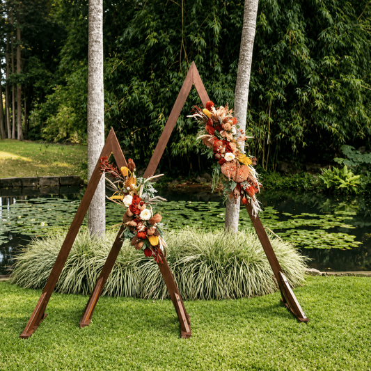 Wooden arch with floral decorations in a garden setting